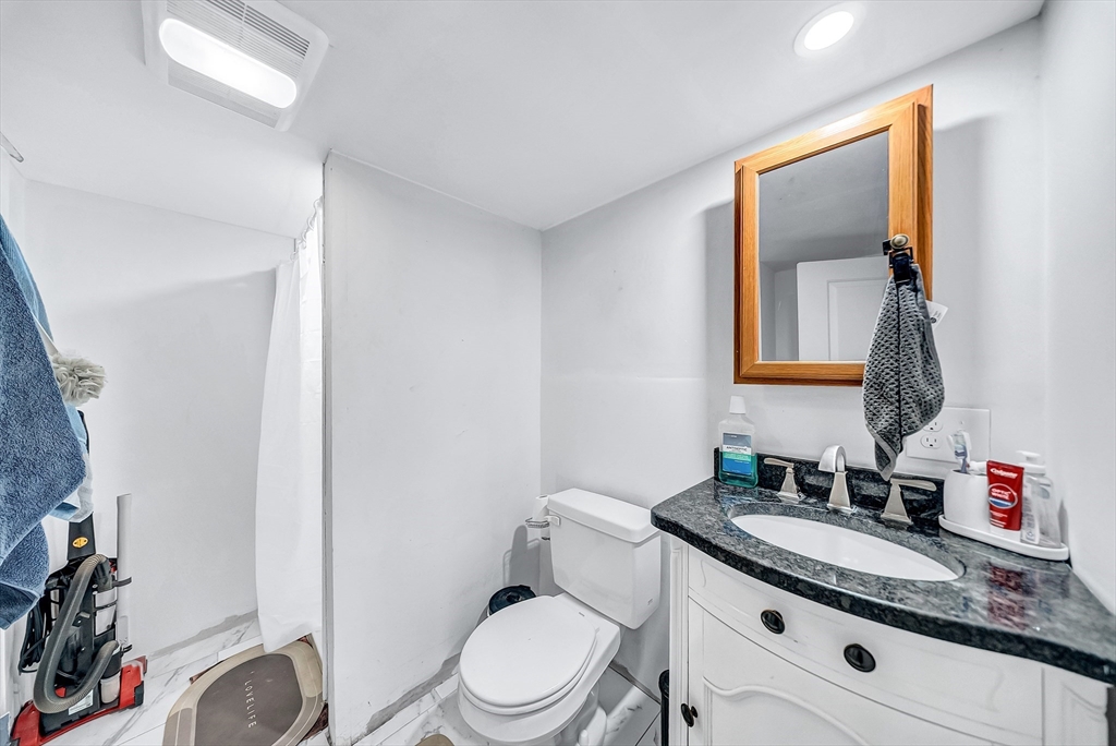 30 Fuller Street Seekonk, MA 02771 - Photo 30 of 42 a bathroom with a granite countertop toilet sink and mirror