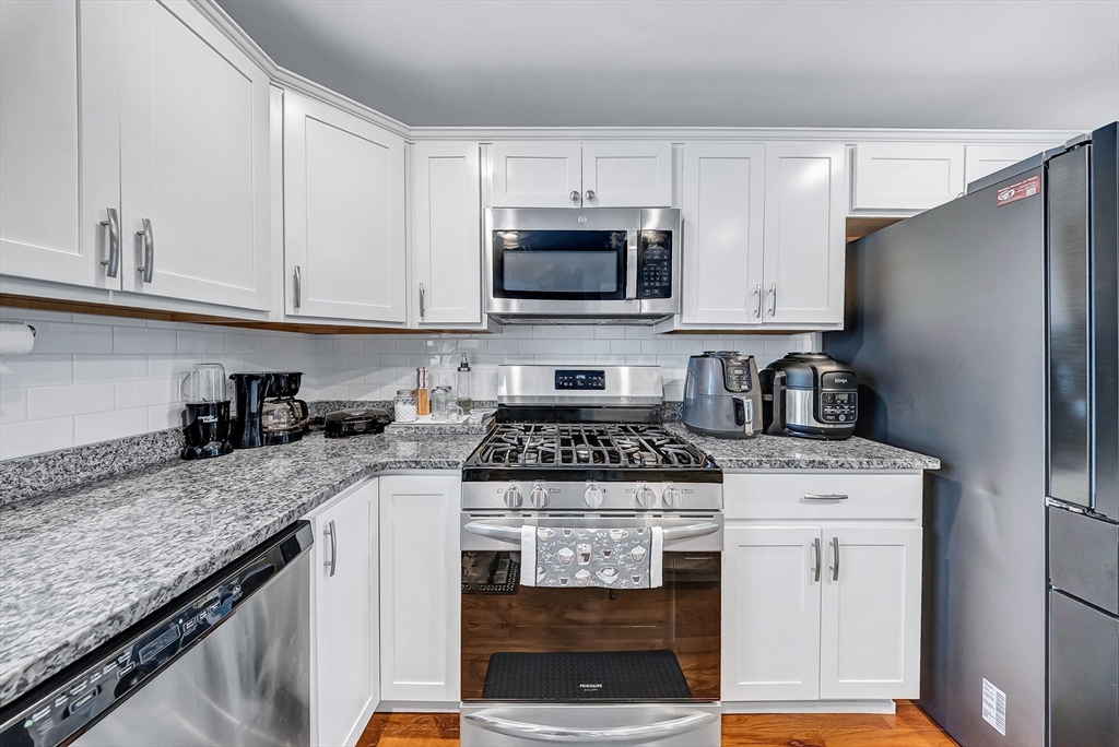 30 Fuller Street Seekonk, MA 02771 - Photo 6 of 42 a kitchen with granite countertop a stove sink and cabinets