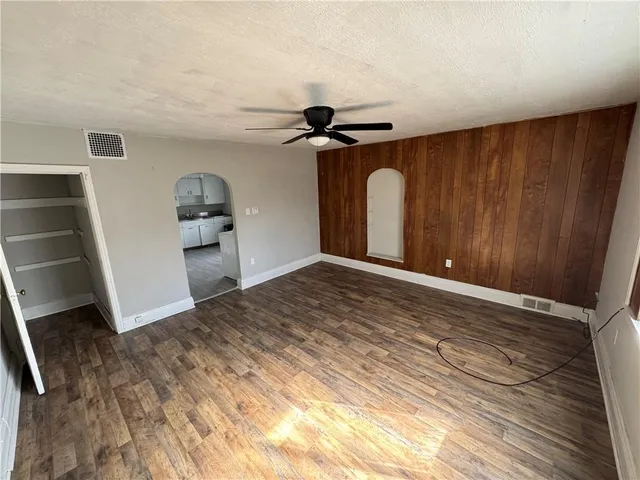 a view of a livingroom with wooden floor and closet