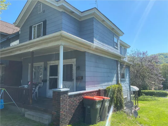 a view of a house with backyard porch and sitting area