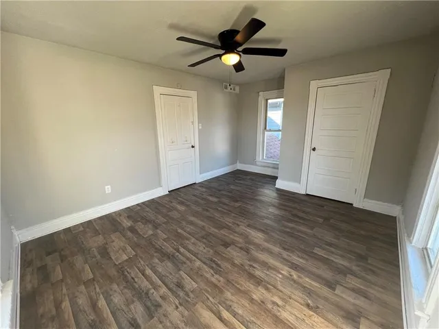 a view of an empty room and wooden floor