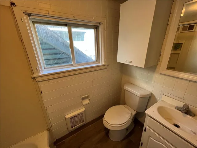 a white toilet sitting next to a bathroom sink