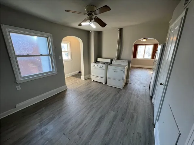 a view of a livingroom with furniture wooden floor and window