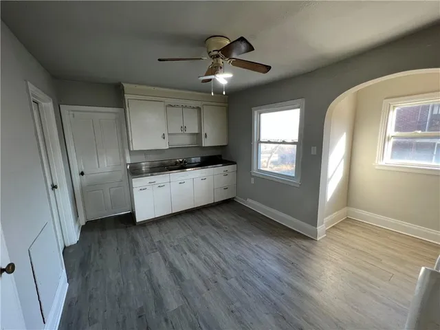 a kitchen with granite countertop a stove a sink and a refrigerator