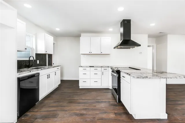 a kitchen with stainless steel appliances kitchen island granite countertop a stove a sink and a refrigerator