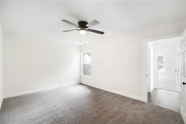 an empty room with a empty space and a ceiling fan
