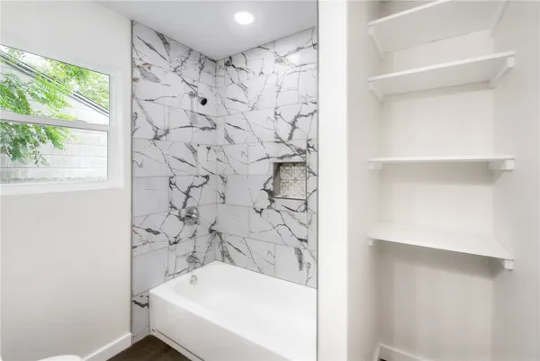 a bathroom with a bathtub and shower