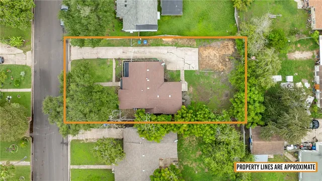 an aerial view of a house with a yard