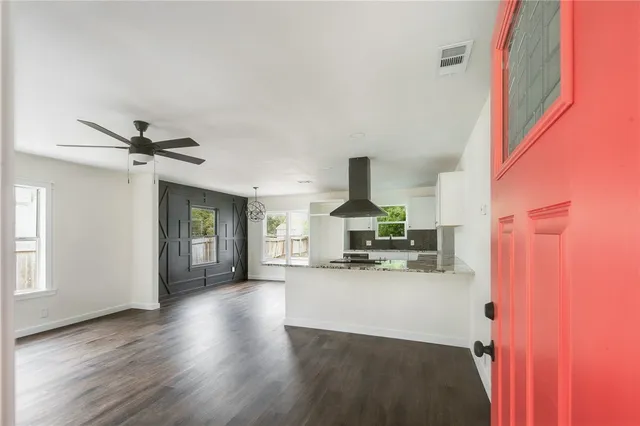a view of a living room hardwood floor and a ceiling fan