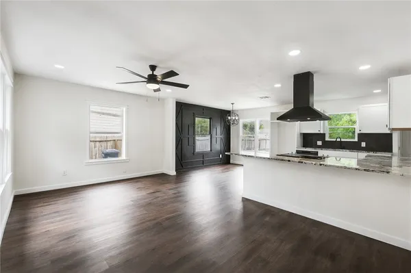 a view of a kitchen with a sink and a stove top oven