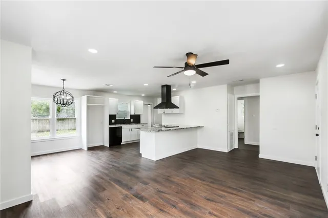 a view of kitchen with sink and refrigerator