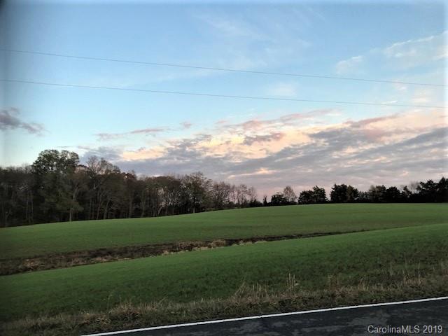 1221 A McIntyre Road Wingate, NC 28174 - Photo 16 of 25 a view of a field with grass and a fence