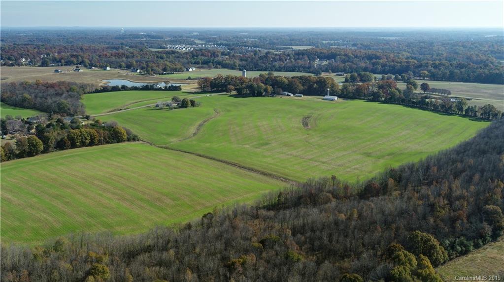1221 A McIntyre Road Wingate, NC 28174 - Photo 7 of 25 an aerial view of residential houses with outdoor space and trees