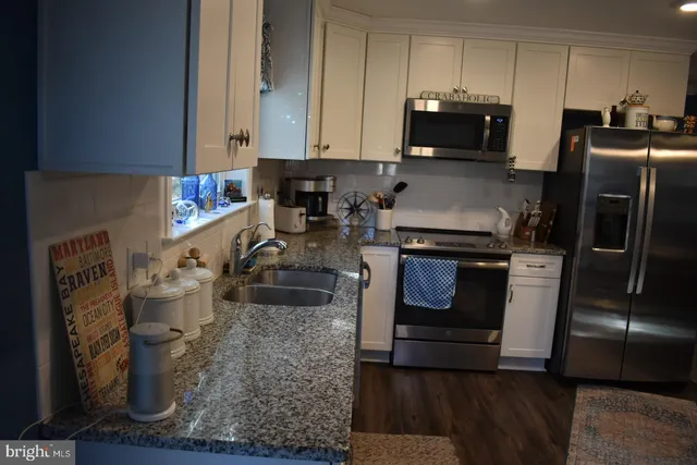a kitchen with a stove microwave and refrigerator