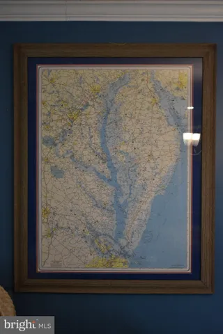 a bedroom with a bed and a lamp on dresser