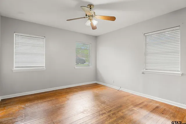 a view of a room with wooden floor and a window