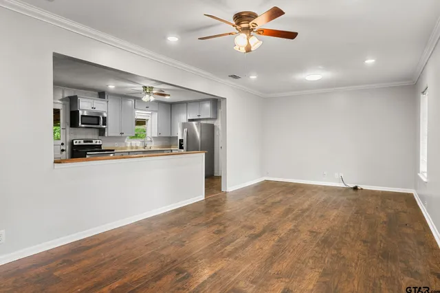 a view of a kitchen with a sink and a refrigerator