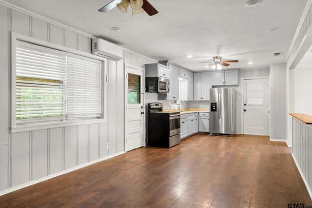 a view of a kitchen with refrigerator and microwave