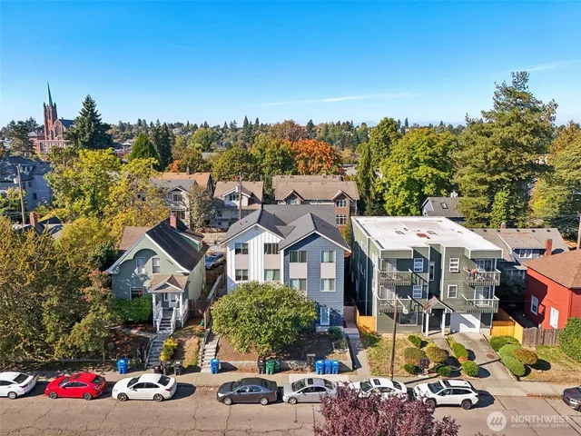 a view of a kitchen with a refrigerator and wooden floor