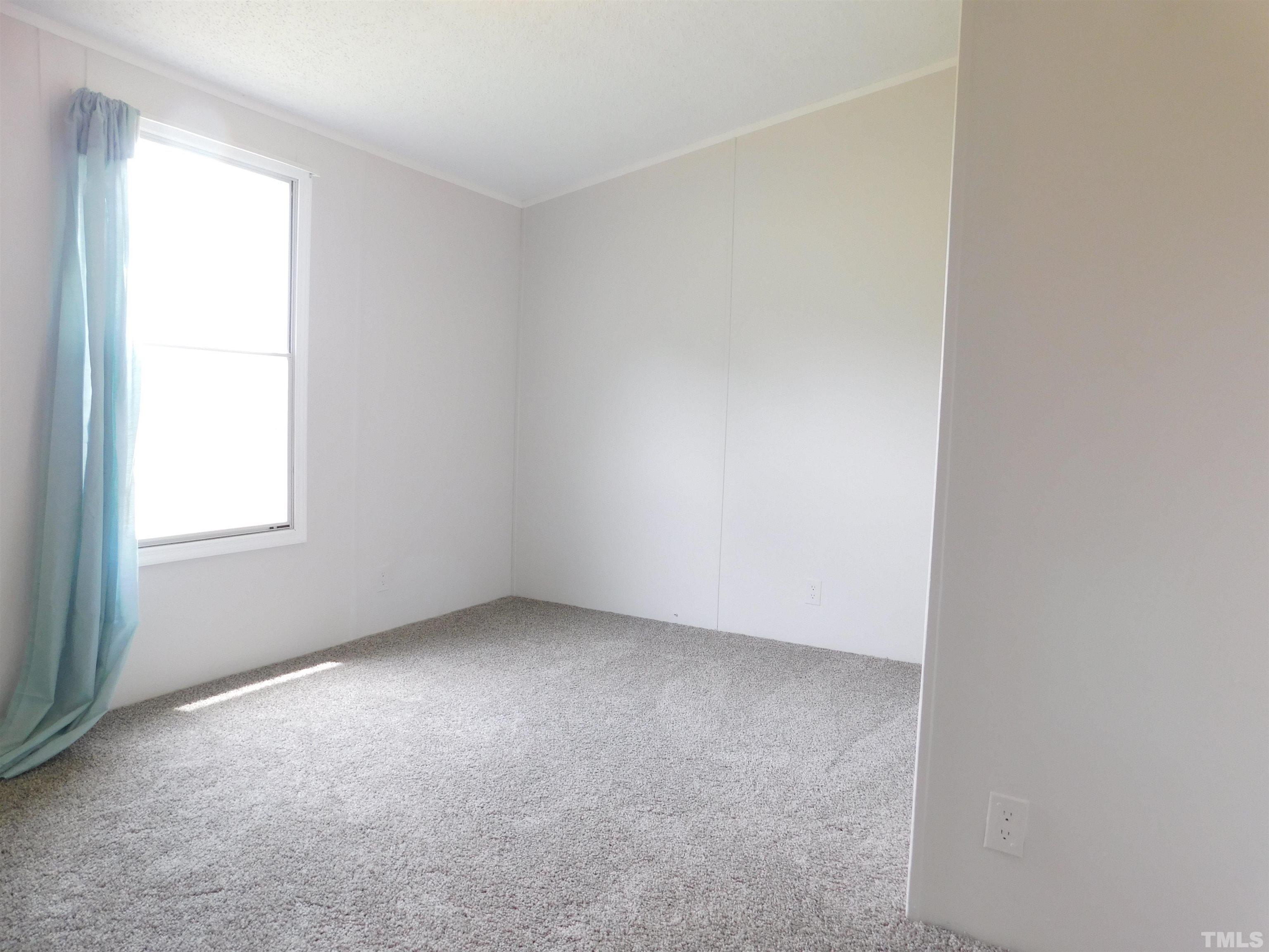 1022 Whitley Road Middlesex, NC 27557 - Photo 7 of 13 an empty room with a window