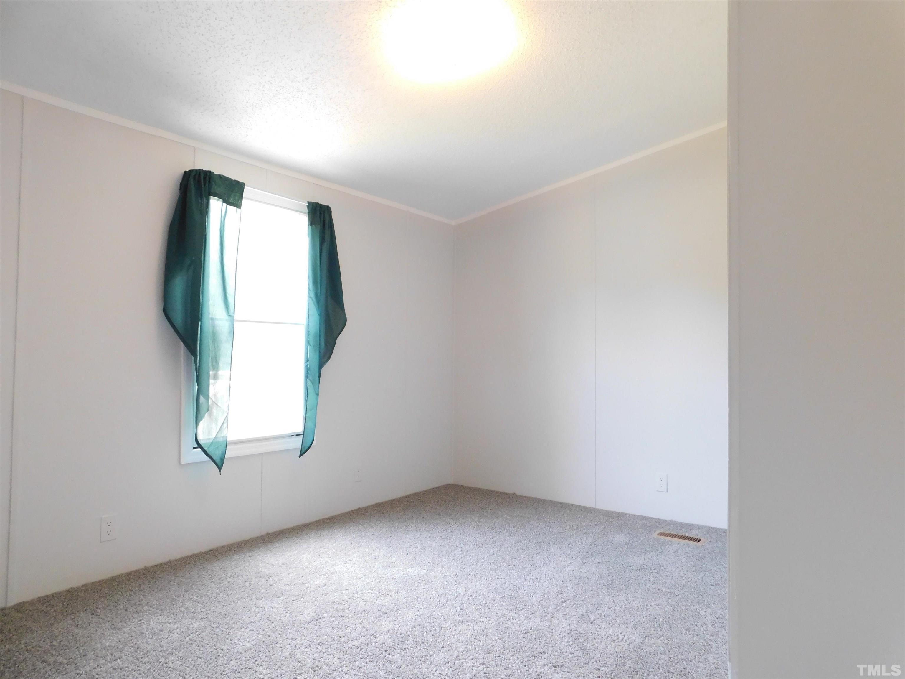 1022 Whitley Road Middlesex, NC 27557 - Photo 8 of 13 an empty room with windows