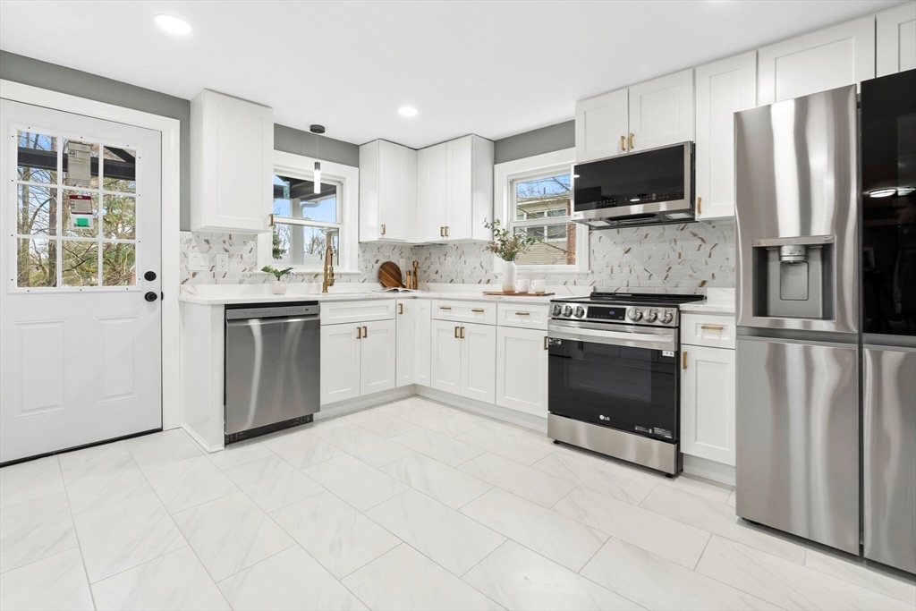 25 Parker Street Newton, MA 02459 - Photo 11 of 38 a kitchen with stainless steel appliances a stove sink microwave refrigerator and cabinets