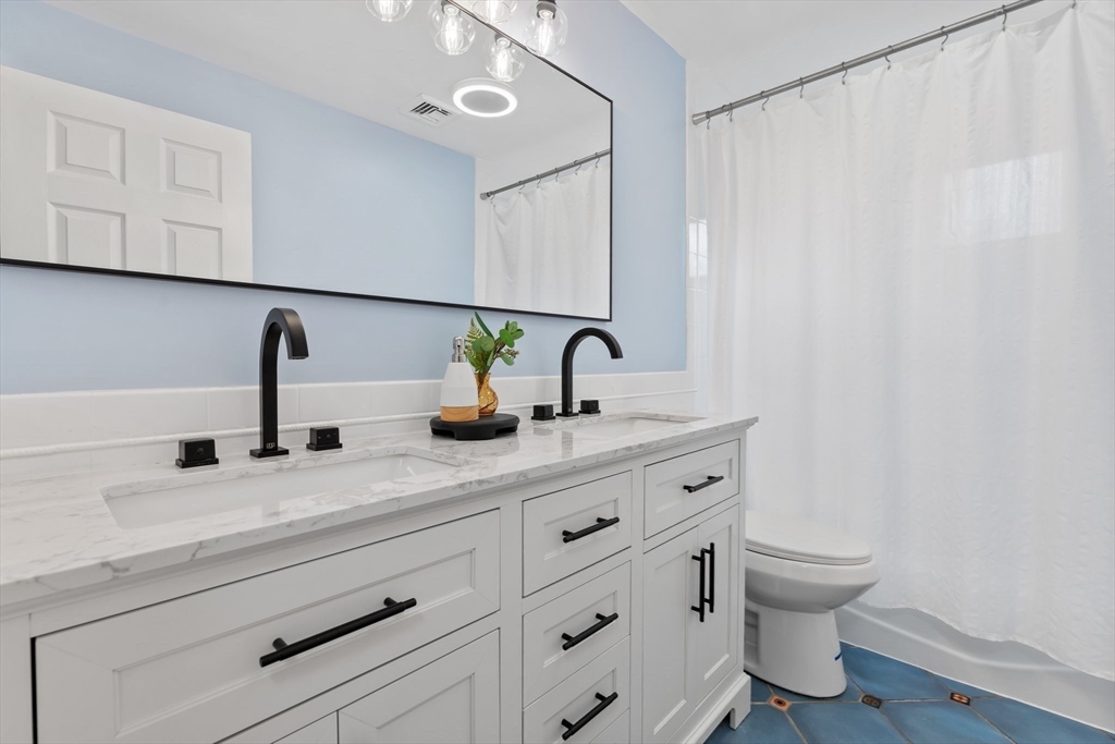 25 Parker Street Newton, MA 02459 - Photo 16 of 38 a bathroom with a sink and a mirror