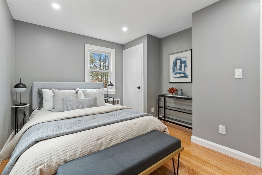 25 Parker Street Newton, MA 02459 - Photo 22 of 38 a bedroom with bed and wooden floor