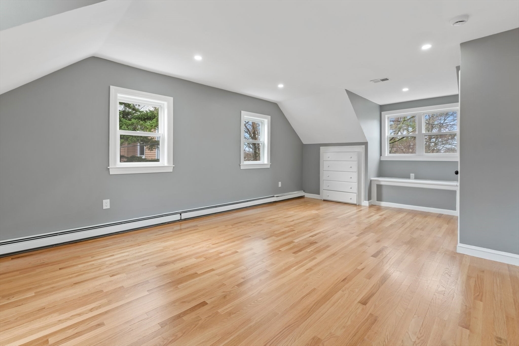 25 Parker Street Newton, MA 02459 - Photo 24 of 38 an empty room with wooden floor and windows