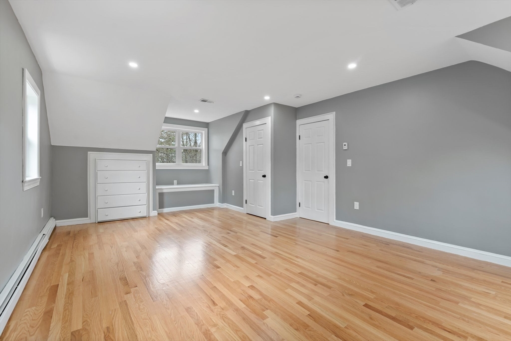 25 Parker Street Newton, MA 02459 - Photo 25 of 38 a view of empty room with wooden floor