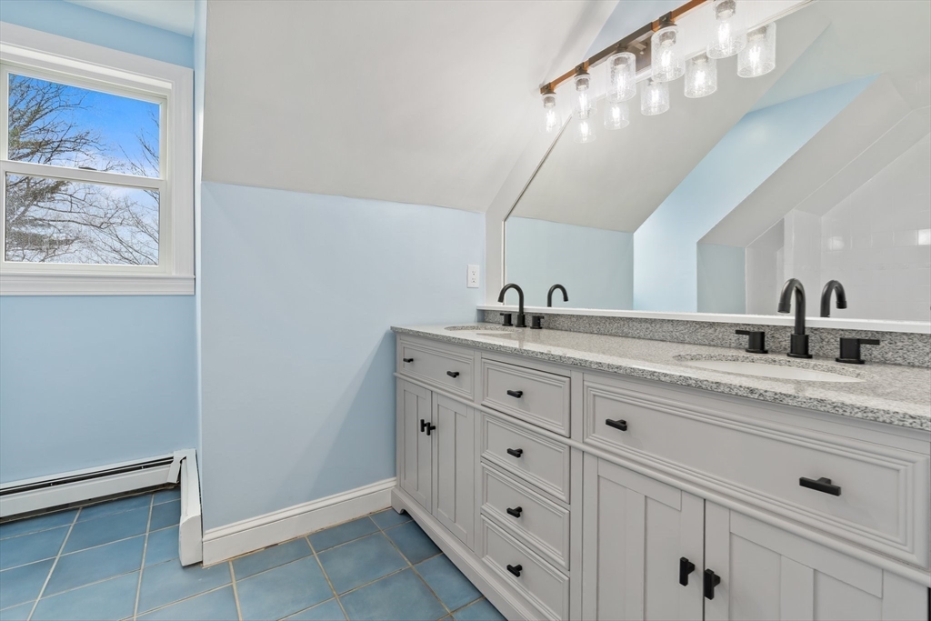 25 Parker Street Newton, MA 02459 - Photo 29 of 38 a bathroom with a sink a vanity and a mirror