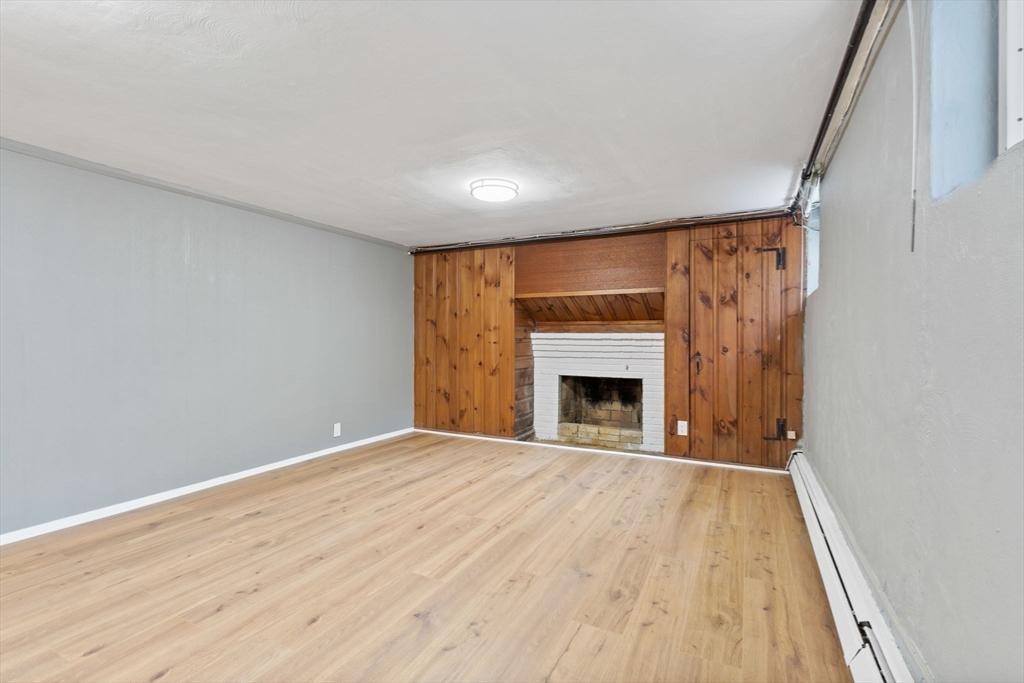 25 Parker Street Newton, MA 02459 - Photo 31 of 38 a view of empty room with wooden floor and fireplace