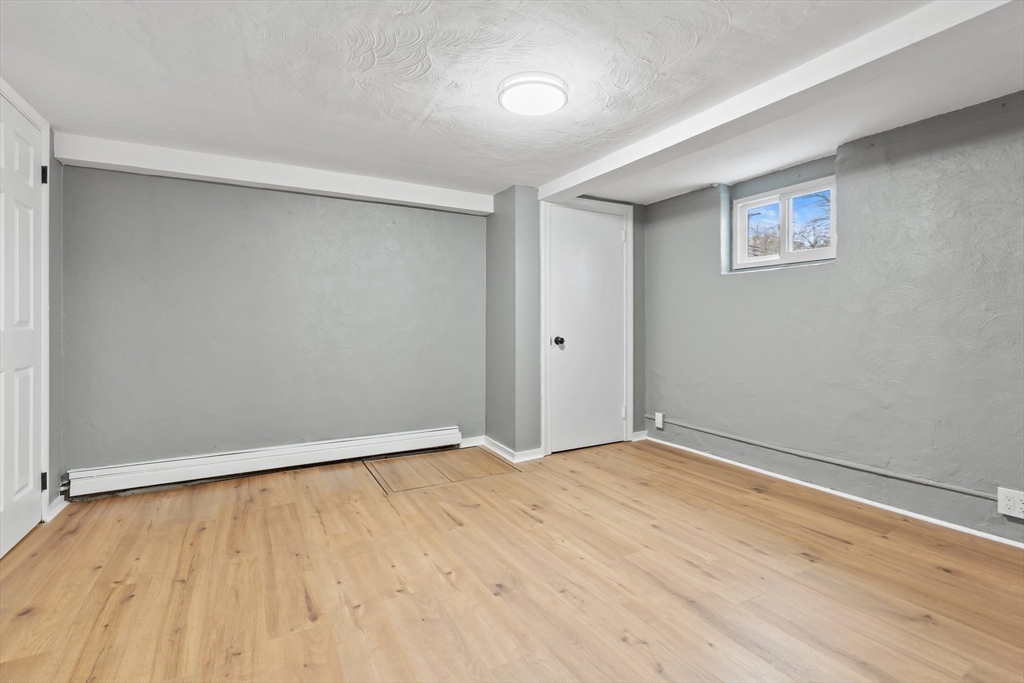 25 Parker Street Newton, MA 02459 - Photo 33 of 38 a view of an empty room with wooden floor and a window