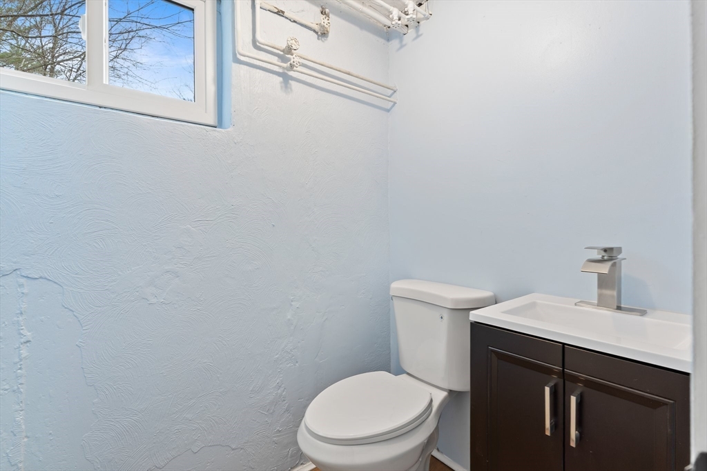25 Parker Street Newton, MA 02459 - Photo 35 of 38 a white toilet sitting next to a bathroom sink