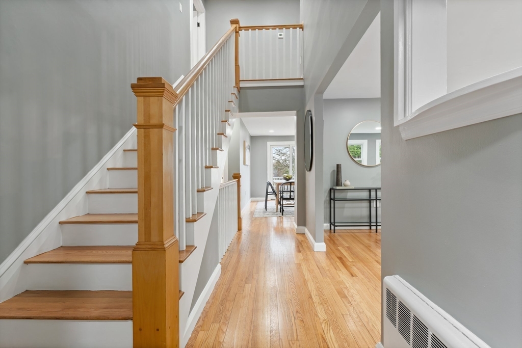 25 Parker Street Newton, MA 02459 - Photo 5 of 38 a view of a hallway with wooden floor and staircase