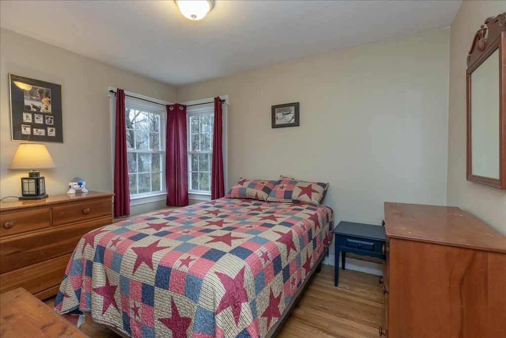 61 Beach Road Salisbury, MA 01952 - Photo 17 of 27 a bedroom with a bed and a lamp with window