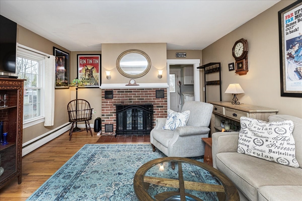61 Beach Road Salisbury, MA 01952 - Photo 5 of 27 a living room with furniture a rug and a fireplace
