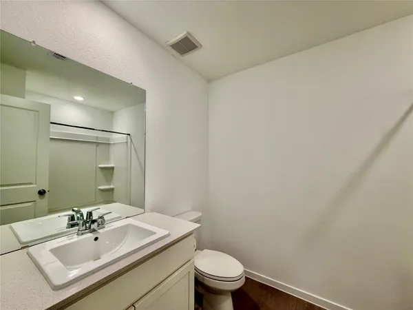 a bathroom with a sink a toilet and mirror