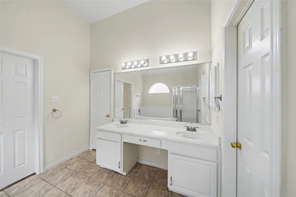 a bathroom with a double vanity sink and a mirror