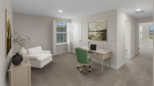 a view of a livingroom with workspace and a couch