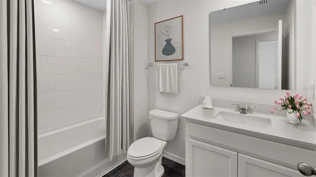 a bathroom with a sink a toilet a mirror and shower