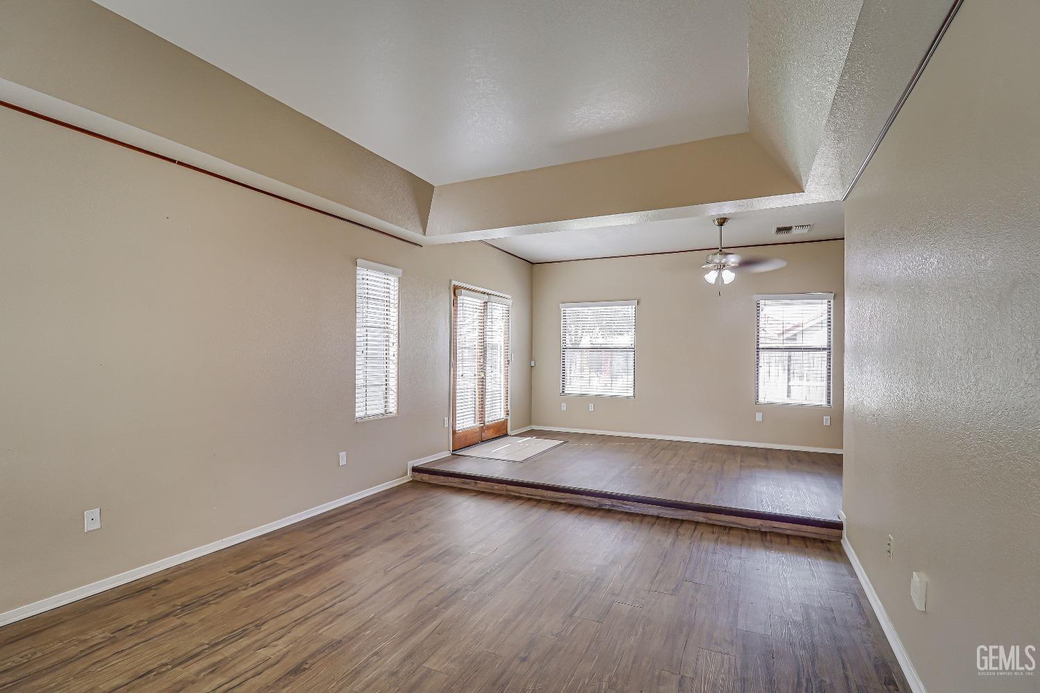 Undisclosed Address Bakersfield, CA 93311 - Photo 11 of 51 an empty room with wooden floor and windows