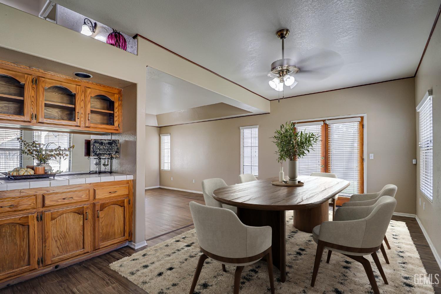 Undisclosed Address Bakersfield, CA 93311 - Photo 16 of 51 a dining room with wooden floor a chandelier a wooden table and chairs