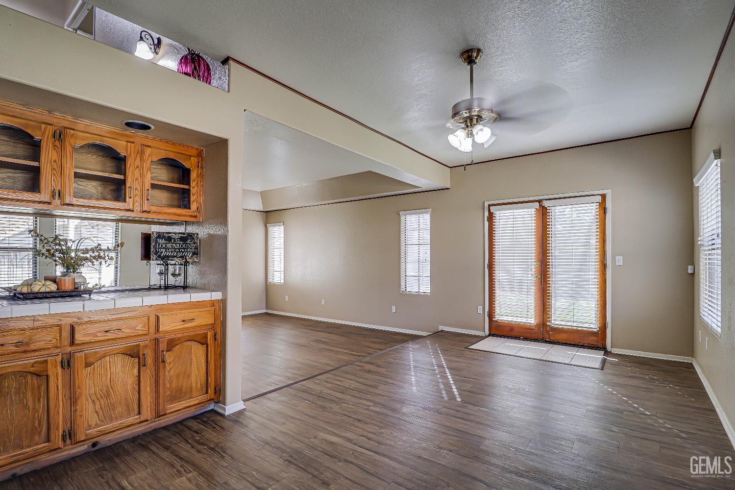 Undisclosed Address Bakersfield, CA 93311 - Photo 17 of 51 a view of an empty room with window and wooden floor