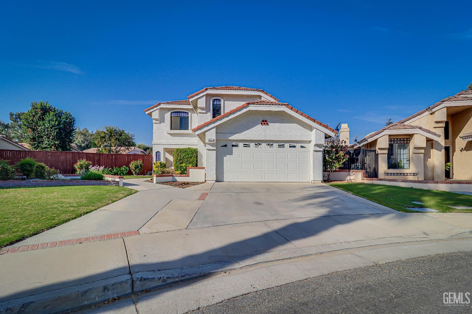 Undisclosed Address Bakersfield, CA 93311 - Photo 2 of 51 a front view of a house with a yard and garage