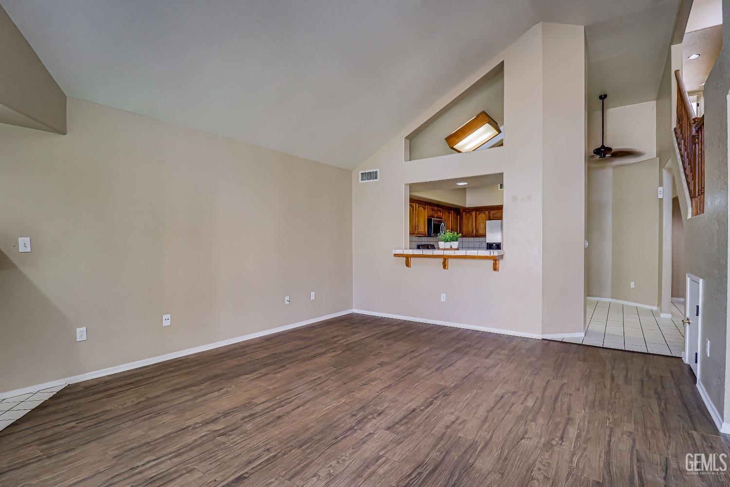 Undisclosed Address Bakersfield, CA 93311 - Photo 21 of 51 an empty room with wooden floor and mirror