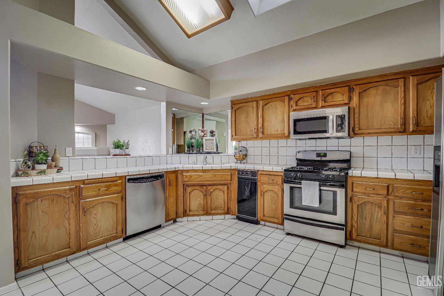 Undisclosed Address Bakersfield, CA 93311 - Photo 23 of 51 a kitchen with stainless steel appliances granite countertop a sink and cabinets