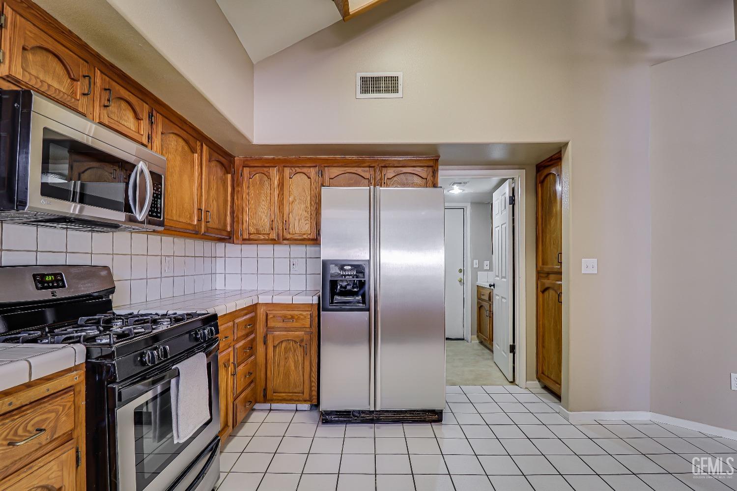 Undisclosed Address Bakersfield, CA 93311 - Photo 25 of 51 a kitchen with stainless steel appliances granite countertop a stove a sink and a refrigerator