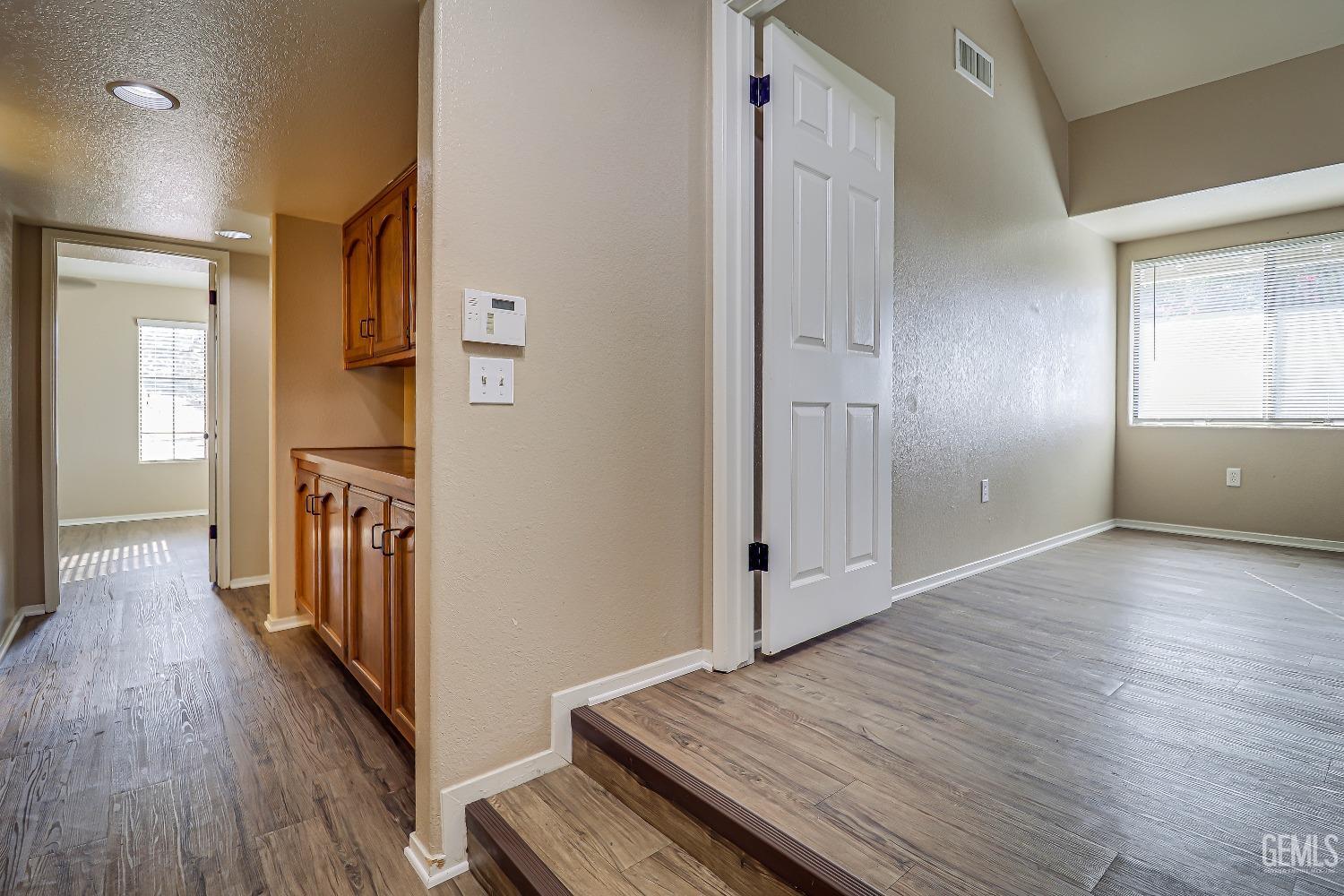 Undisclosed Address Bakersfield, CA 93311 - Photo 27 of 51 an empty room with wooden floor and windows