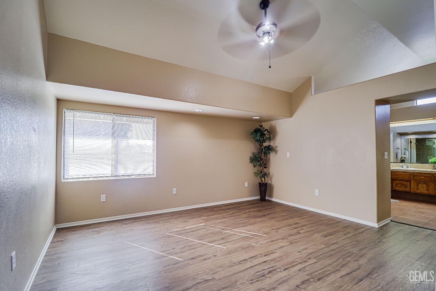 Undisclosed Address Bakersfield, CA 93311 - Photo 29 of 51 wooden floor in an empty room with a window